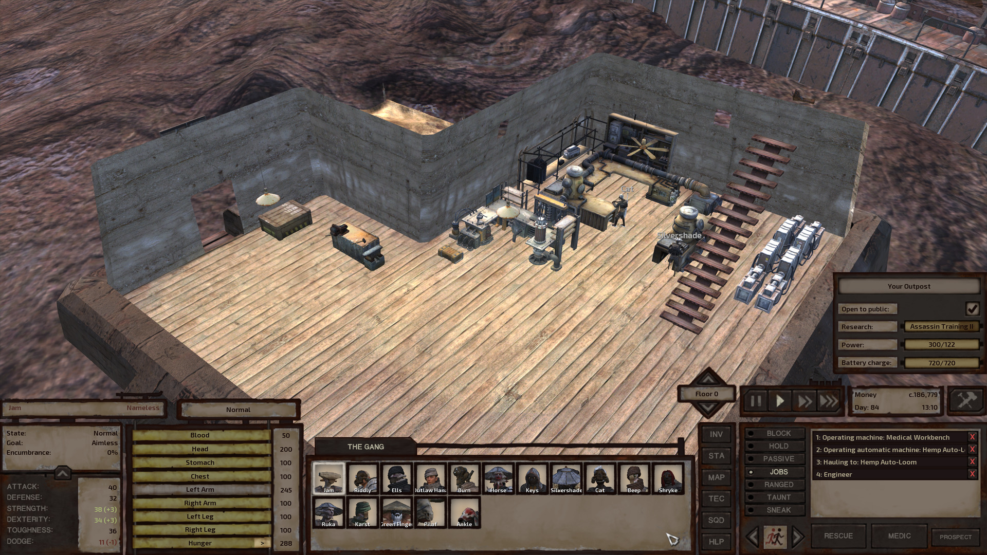 An L-shaped building interior. At one extremity is the door and copper sheet workbench; at the other, the large and small research benches fill the space beside the stairs. The crook of the L is empty.